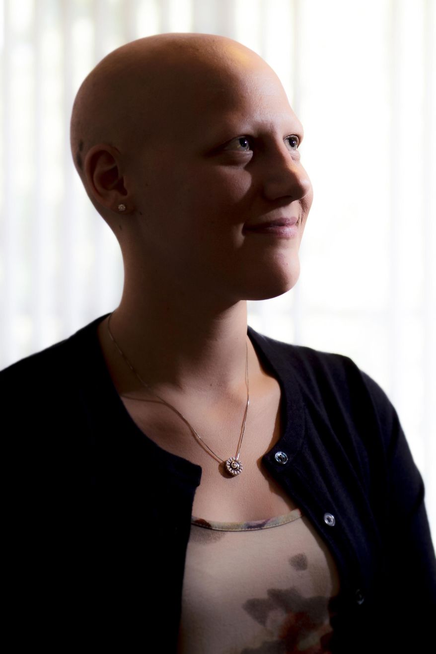 In this photo taken on Aug. 19, 2014, 21-year-old Sydney Olson, of Sutton, Neb. poses for a photo at her apartment. Olson, who lives with alopecia, an autoimmune skin disease resulting in hair loss, and recently published a children's book, "The Curse of the Fates," in an effort to help others and to promote awareness of the disease. (AP Photo/The Journal-Star, Kristin Streff) LOCAL TELEVISION OUT; KOLN-TV OUT; KGIN-TV OUT; KLKN-TV OUT