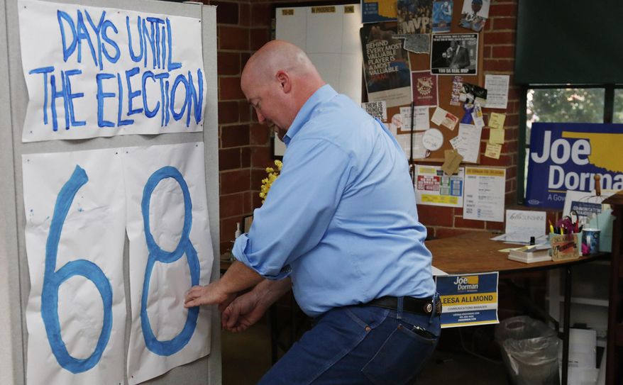 In this Thursday, Aug. 28, 2014 photo, Joe Dorman, Democratic candidate for governor, changes the number on an election countdown calendar in his campaign headquarters in Oklahoma City. (AP Photo/Sue Ogrocki)