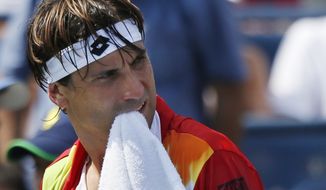 David Ferrer, of Spain, walks to his chair during a break between games against Gilles Simon, of France, during the third round of the 2014 U.S. Open tennis tournament, Sunday, Aug. 31, 2014, in New York. (AP Photo/Seth Wenig)