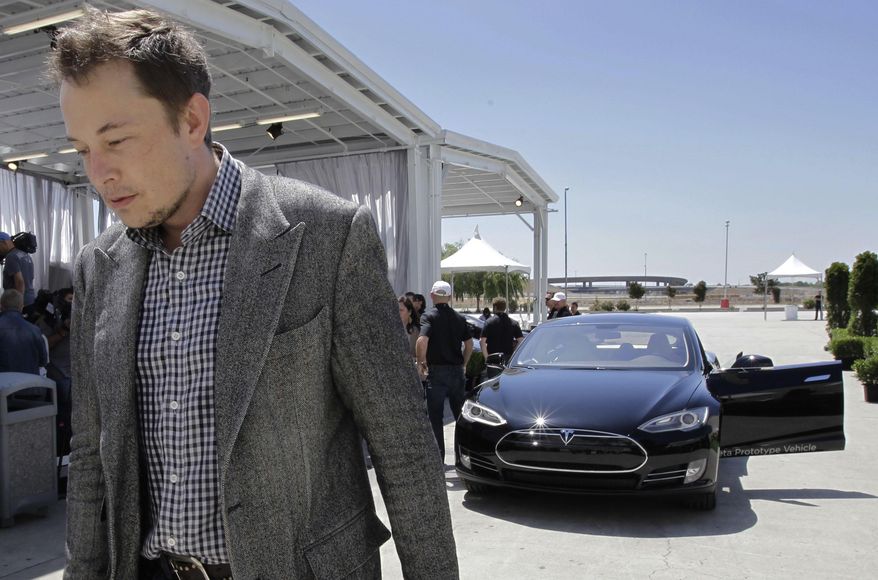 FILE - In this Friday, June 22, 2012 file photo, Tesla CEO Elon Musk walks past the Tesla Model S after a news conference at the Tesla factory in Fremont, Calif. Five states are on the short list for a $5 billion factory that Tesla Motors plans to build so it can crank out batteries for a new generation of electric cars. The package of economic incentives that each state offers will help determine where Tesla builds the factory — Nevada, California, Texas, Arizona or New Mexico. Tesla CEO Elon Musk has said the winning state will shoulder about 10 percent of the total cost, meaning at least $500 million worth of incentives.  (AP Photo/Paul Sakuma, File)