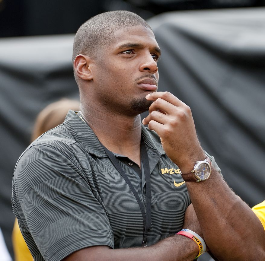 Former Missouri player Michael Sam watches pregame festivities before the start of the South Dakota State-Missouri NCAA college football game Saturday, Aug. 30, 2014, in Columbia, Mo. The St. Louis Rams cut Michael Sam, the first openly gay player drafted by an NFL team. Coach Jeff Fisher repeated over and over that it was purely a football decision. (AP Photo/L.G. Patterson)