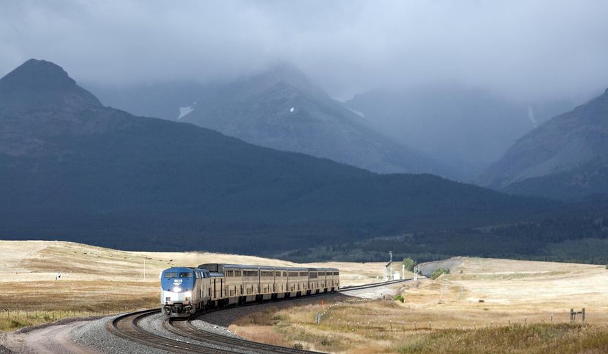 FILE - In this Sept. 18, 2011 file photo, Amtrak&#39;s Empire Builder rounds a turn near East Glacier Park, Mont. The U.S. Bureau of Land Management says it made a mistake giving active railroads too much discretion on what can be built on 200-foot-wide rights-of-way crossing thousands of miles of public land in 11 western states.  (AP Photo/Flathead Beacon, Justin Franz, File)