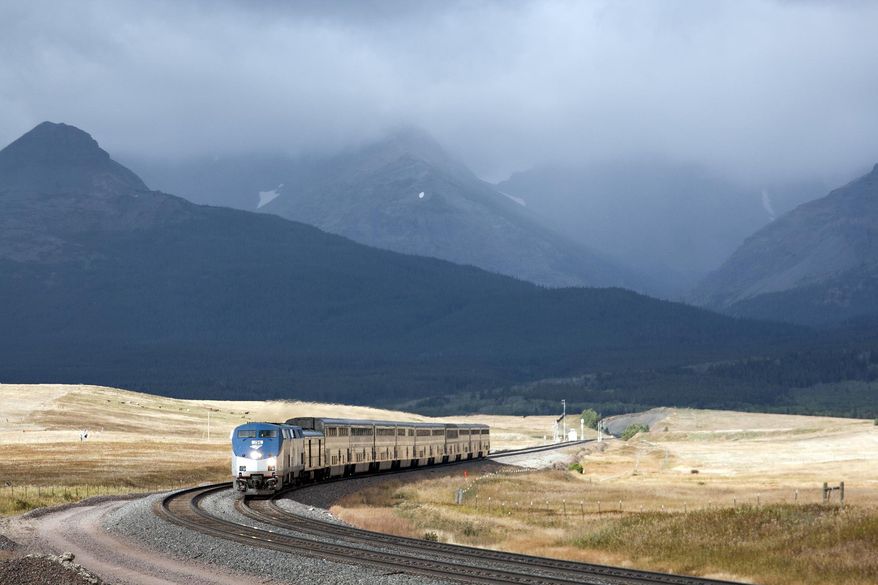 FILE - In this Sept. 18, 2011 file photo, Amtrak's Empire Builder rounds a turn near East Glacier Park, Mont. The U.S. Bureau of Land Management says it made a mistake giving active railroads too much discretion on what can be built on 200-foot-wide rights-of-way crossing thousands of miles of public land in 11 western states. (AP Photo/Flathead Beacon, Justin Franz, File)