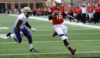 Maryland quarterback C.J. Brown (16) scores a touchdown past James Madison linebacker Rhakeem Stallings (7) during the first half of an NCAA college football game, Saturday, Aug. 30, 2014, in College Park, Md. (AP Photo/Nick Wass)