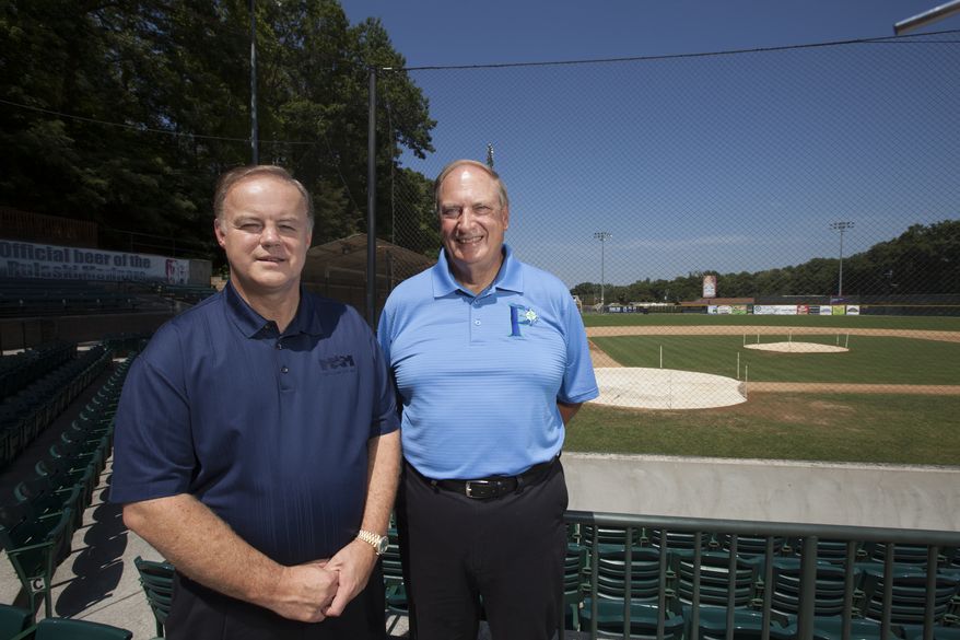 Incoming owner David Hagan, left, stands with outgoing owner, Wayne Carpenter, on the concourse of Calfee Park. Hagan and a business partner, Larry Shelor, purchased the park from Carpenter and his business partners, Tom Compton and Rick Mansell, who had operated the park for 25 years.