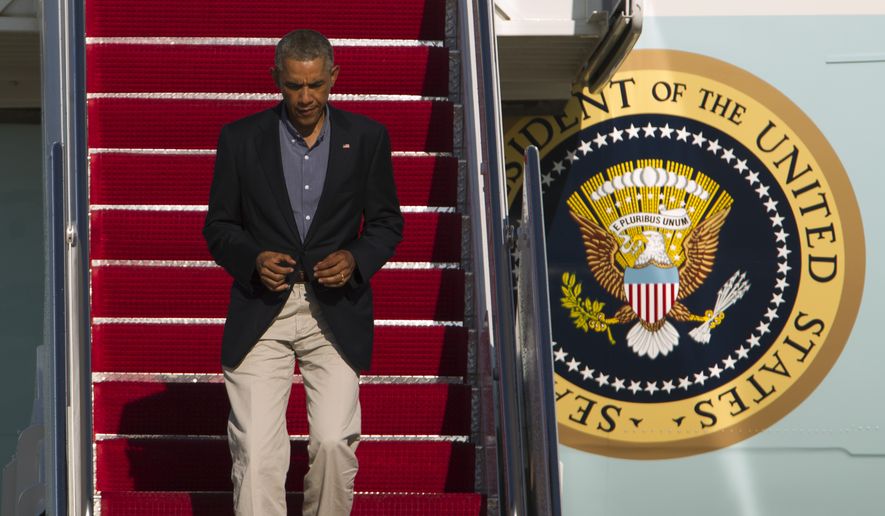 President Barack Obama walks down the stairs of Air Force One upon arrival at Andrews Air Force Base, Md., Monday, Sept. 1, 2014. (AP Photo/Jose Luis Magana)