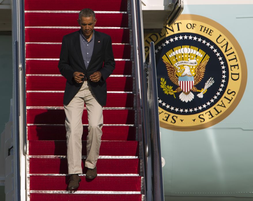 President Barack Obama walks down the stairs of Air Force One upon arrival at Andrews Air Force Base, Md., Monday, Sept. 1, 2014. (AP Photo/Jose Luis Magana)