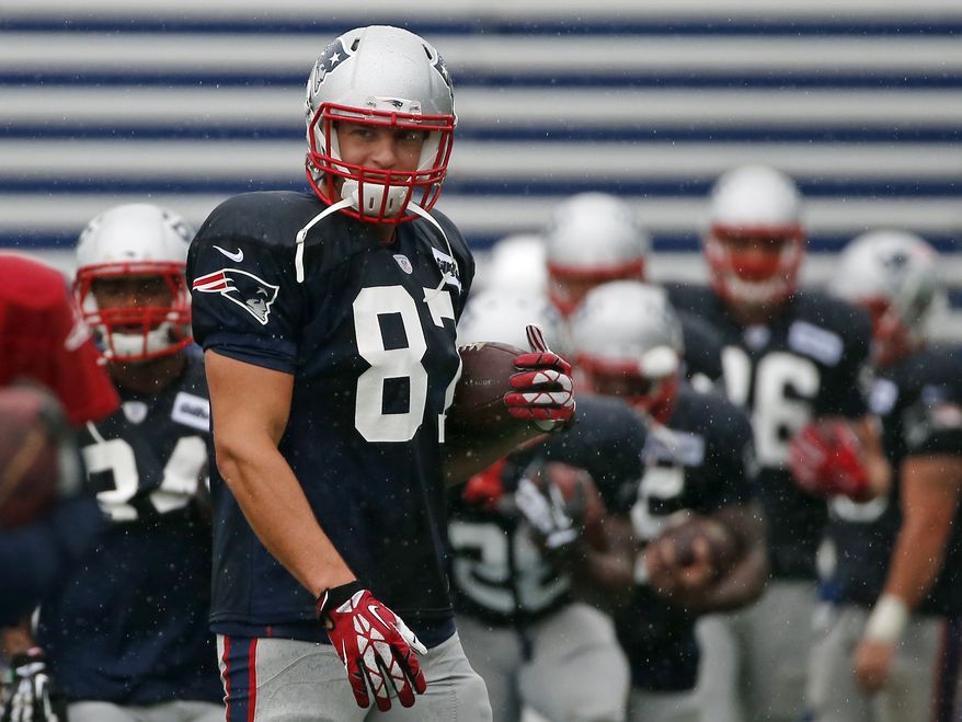 New England Patriots tight end Rob Gronkowski (87) carries a football during an NFL football training camp joint practice of the New England Patriots and the Philadelphia Eagles in Foxborough, Mass., Wednesday, Aug. 13, 2014. (AP Photo/Elise Amendola)