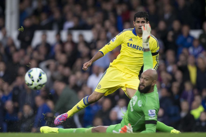 Chelsea's Diego Costa, top, is thwarted by Everton's goalkeeper Tim Howard during their English Premier League soccer match at Goodison Park Stadium, Liverpool, England, Saturday Aug. 30, 2014. (AP Photo/Jon Super)
