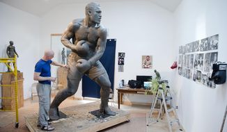 In this Aug. 14, 2014 photo, artist Stephen Layne works on a sculpture of boxing heavyweight champion Joe Frazier in Philadelphia. Next year, the sculpture is expected to be placed near the city&#x27;s sports stadiums, ending a hurdle-strewn saga that included fundraising problems and the death of the original sculptor. Frazier died in 2011. (AP Photo/Matt Rourke)