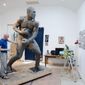 In this Aug. 14, 2014 photo, artist Stephen Layne works on a sculpture of boxing heavyweight champion Joe Frazier in Philadelphia. Next year, the sculpture is expected to be placed near the city&#39;s sports stadiums, ending a hurdle-strewn saga that included fundraising problems and the death of the original sculptor. Frazier died in 2011. (AP Photo/Matt Rourke)