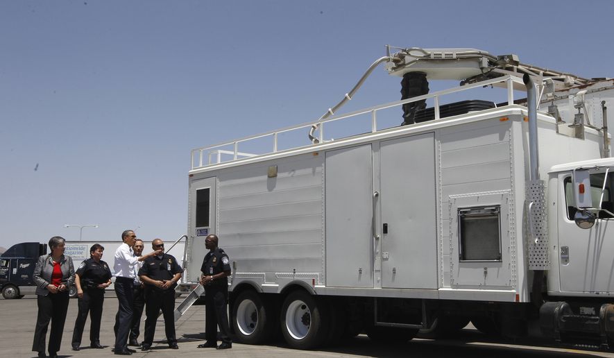**FILE** President Barack Obama and Homeland Security Secretary Janet Napolitano examine an x-ray vehicle as they tour the Bridge of America Cargo Facility in El Paso, Texas, on May 10, 2011, during their visit to the U.S.-Mexico border. (Associated Press)