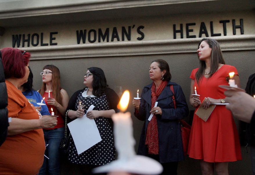 File - In this March 6, 2014 file photo, over 40 people hold a candle light vigil in front of the Whole Women's HealthClinic in McAllen, Texas. The clinic is reopening after a federal judge on Friday, Aug. 29, 2014, blocked part of sweeping new Texas abortion restrictions that also shuttered other facilities statewide six months ago. (AP Photo/ The Monitor, Delcia Lopez, File)
