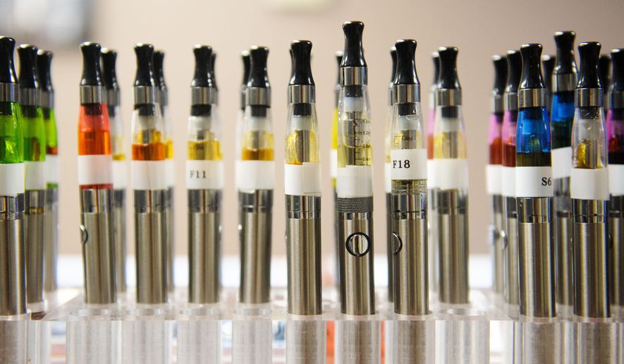 In this July 23, 2014 photo are a variety of e-cigarette at Aqueous Vapor in Columbia, Mo. Gov. Jay Nixon is eliciting support from health professionals as he tries to persuade Missouri lawmakers to sustain his veto of legislation dealing with electronic cigarettes.(AP Photo/The Columbia Daily Tribune, Nick Schnelle)