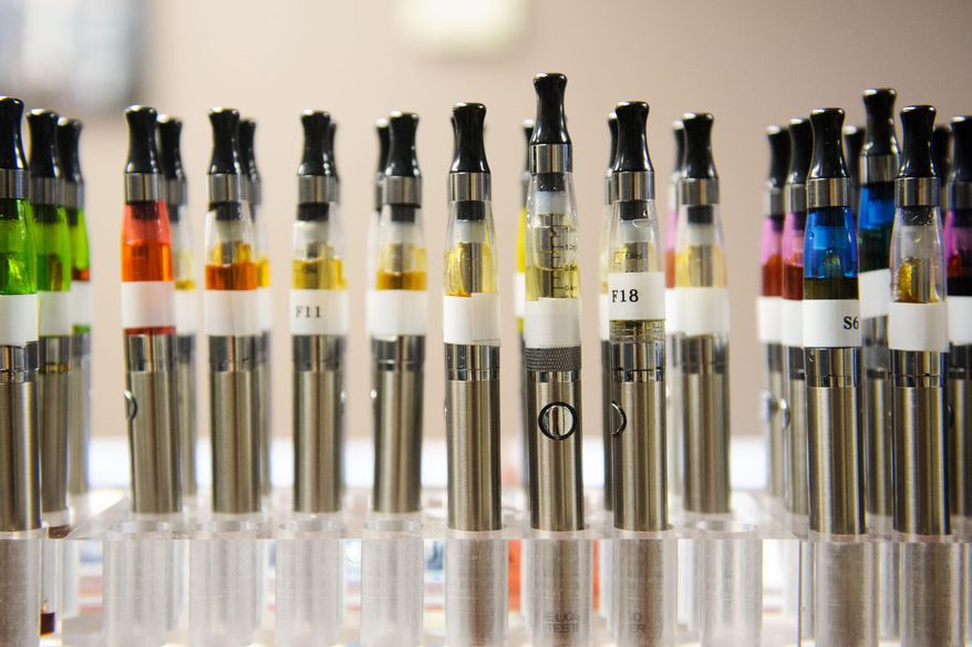 In this July 23, 2014 photo are a variety of e-cigarette at Aqueous Vapor in Columbia, Mo. Gov. Jay Nixon is eliciting support from health professionals as he tries to persuade Missouri lawmakers to sustain his veto of legislation dealing with electronic cigarettes.(AP Photo/The Columbia Daily Tribune, Nick Schnelle)