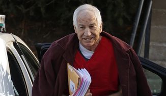 In this Jan. 10, 2013, file photo, former Penn State assistant football coach Jerry Sandusky arrives at the Centre County Courthouse for a post-sentencing hearing in Bellefonte, Pa. (AP Photo/Gene J. Puskar, File)