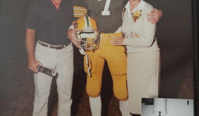 Jay, shown with his father Jim and mother Kathy, played quarterback at Chamberlain High School in Tampa. (Cliff McBride/SPECIAL TO THE WASHINGTON TIMES)