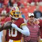 Redskins coach Jay Gruden said it&#39;s his job to get the most out of quarterback Robert Griffin III and there needs to be an open relationship and trust between the two of them. (Preston Keres/Special To The Washington Times)