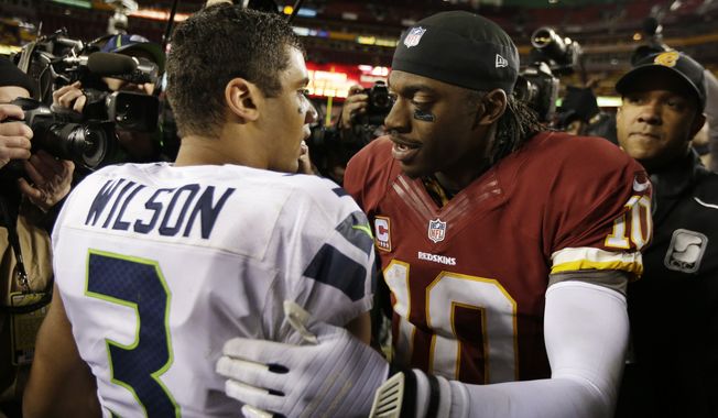 Seattle Seahawks quarterback Russell Wilson greets Washington Redskins quarterback Robert Griffin III after an NFL wild card playoff football game in Landover, Md., Sunday, Jan. 6, 2013. The Seahawks defeated the Redskins 24-14. (AP Photo/Evan Vucci)