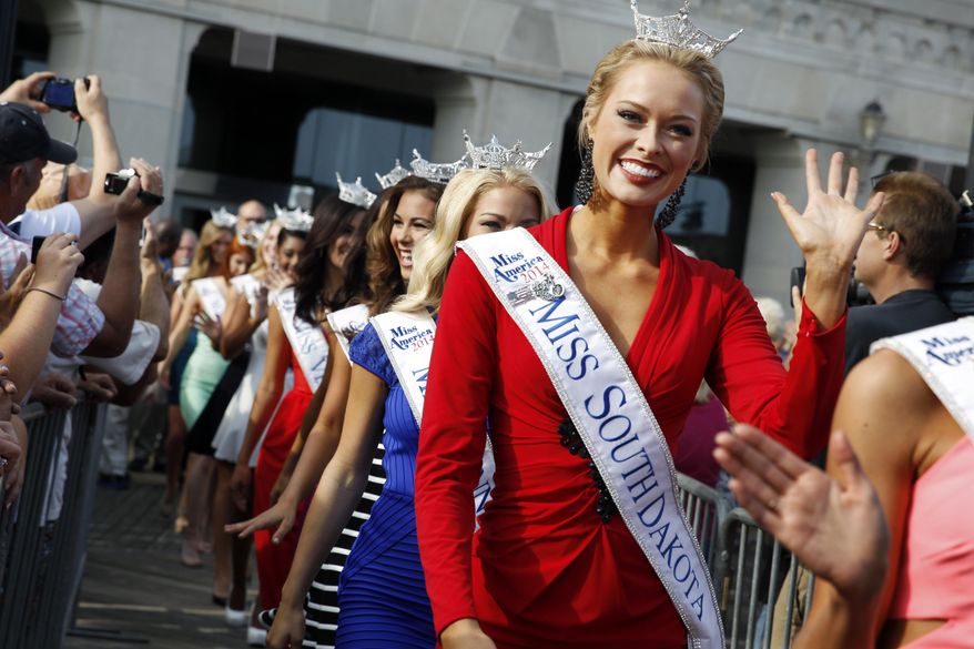Miss South Dakota Meridith Gould waves during Miss America Pageant arrival ceremonies Wednesday, Sept. 3, 2014, in Atlantic City, N.J. Miss America contestants from all 50 states, the District of Columbia, Puerto Rico and the U.S. Virgin Islands will appear Wednesday afternoon at the traditional welcoming ceremony across from Boardwalk Hall. (AP Photo/Mel Evans)