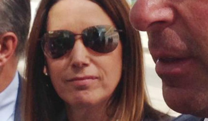 Diana Durand stops outside federal court in the Brooklyn borough of New York, Wednesday, Sept. 03, 2014, after pleading guilty to charges she lined up straw donors for U.S. Rep. Michael Grimm’s 2010 campaign. Durand, who was romantically involved with the Texas congressman, admitted she had asked "two friends" to make $12,000 contributions to Grimm and another politician and then secretly reimbursed them as a way to circumvent campaign contribution limits. At right is her attorney Stuart Kaplan. (AP Photo/Tom Hays)