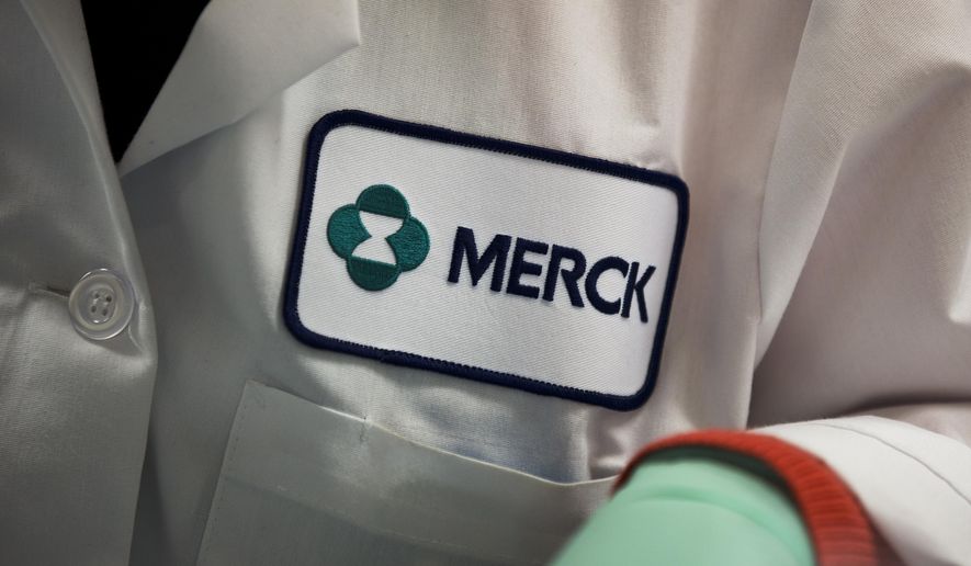 FILE - In this Thursday, Feb. 28, 2013 file photo, a Merck logo is placed on scientist's lab coat in West Point, Pa. The Food and Drug Administration on Thursday, Sept. 4, 2014 said it has granted accelerated approval to Merck's Keytruda, for treating melanoma that's spread or can't be surgically removed, in patients previously treated with another drug. (AP Photo/Matt Rourke, File)