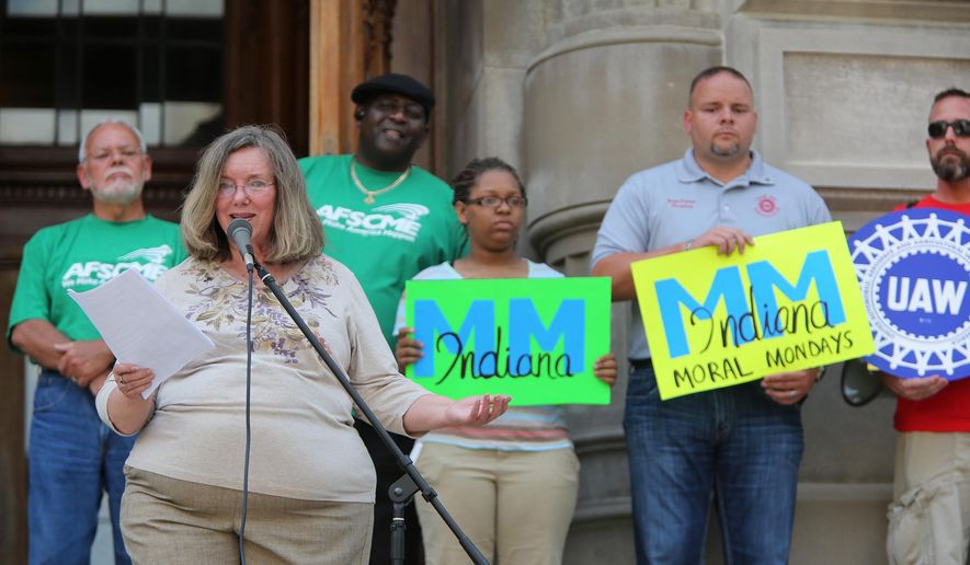 ADVANCE FOR SUNDAY, SEPT. 7 AND THEREAFTER - In a Thursday, Aug. 21, 2014 photo, Nancy Holle leads a rally at the Statehouse, to kick off Indiana Moral Mondays. Indiana Moral Mondays is one of a dozen groups cropping up nationwide with the goal of rolling back what they call “extremist” state laws. (AP Photo/The Indianapolis Star, Kelly Wilkinson) NO SALES