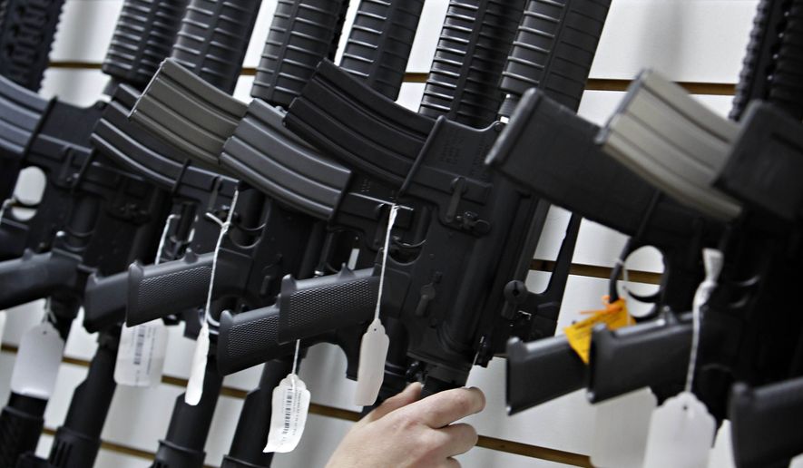 An Arizona made AR-15 is pulled from the display at Caswells Shooting Range Tuesday, April 6, 2010, in Mesa, Ariz. (AP Photo/Matt York) ** FILE **