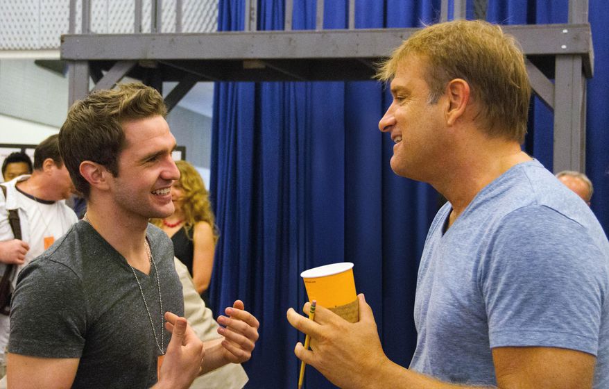 This photo provided by Disney Theatrical Productions shows actor, Dan DeLuca, left, and director, Jeff Calhoun, during rehearsals for "Newsies" at New 42nd Street Studios on Wednesday, Sept. 3, 2014, in New York. The North American company of the Broadway hit “Newsies” is about to high-kick its way through a 25-city tour and its being led by the 22-year-old actor who’ll make a triumphant homecoming in Pittsburgh in time for Thanksgiving. (AP Photo/Disney Theatrical Productions)