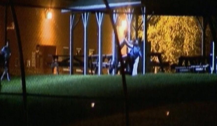 In this image made from video, teens chase and assault a man who appears to be a staff member at the the Woodland Hills Youth Development Center in Nashville, Tenn., Wednesday night, Sept. 3, 2014. Officials said about 28 teens, some of whom were part of the breakout, kicked out metal panels underneath the windows in a common area to reach the yard. This time, police formed a ring around the center's perimeter fence to try to prevent another escape. (AP Photo/WTVF TV)