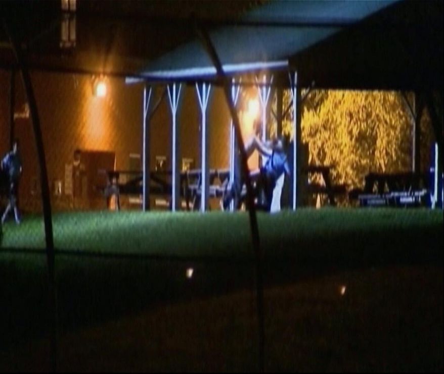 In this image made from video, teens chase and assault a man who appears to be a staff member at the the Woodland Hills Youth Development Center in Nashville, Tenn., Wednesday night, Sept. 3, 2014. Officials said about 28 teens, some of whom were part of the breakout, kicked out metal panels underneath the windows in a common area to reach the yard. This time, police formed a ring around the center's perimeter fence to try to prevent another escape. (AP Photo/WTVF TV)