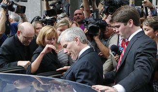 Former Virginia Gov. Bob McDonnell, center, is mobbed by media as he gets into a car with his son, Bobby, right, after McDonnell and his wife, former first lady Maureen McDonnell, were convicted on multiple counts of corruption at Federal Court in Richmond, Va., Thursday, Sept. 4, 2014. A federal jury in Richmond convicted Bob McDonnell of 11 of the 13 counts he faced; Maureen McDonnell was convicted of nine of the 13 counts she had faced. Sentencing was scheduled for Jan. 6.  (AP Photo/Steve Helber)