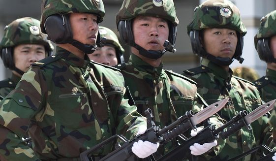 Soldiers from the People&#39;s Liberation Army (PLA) 6th Armored Division carry the Chinese type 97 semiautomatic machine guns at their military base on the outskirts of Beijing. (AP Photo/Andy Wong) ** FILE **