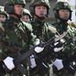 Soldiers from the People&#39;s Liberation Army (PLA) 6th Armored Division carry the Chinese type 97 semiautomatic machine guns at their military base on the outskirts of Beijing. (AP Photo/Andy Wong) ** FILE **