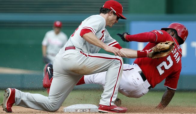 Washington Nationals center fielder Denard Span is tagged out by Philadelphia Phillies second baseman Chase Utley on the steal attempt of second base during the third inning of a baseball game at Nationals Park, Saturday, Sept. 6, 2014, in Washington. (AP Photo/Alex Brandon)