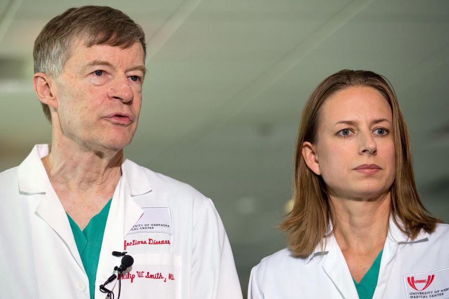 Dr. Philip W. Smith, left, and Dr. Angela Hewlett speak during a news conference about the condition of Dr. Rick Sacra, Sunday, Sept. 7, 2014, in Omaha Neb. Sacra who became infected with Ebola arrived at the Nebraska Medical Center on Friday for treatment in the hospital's specialized 10-bed isolation unit. The 51-year-old Sacra is the third American aid worker to be sickened with the Ebola virus. (AP Photo/The World-Herald, Sarah Hoffman) MAGS OUT; ALL NEBRASKA LOCAL BROADCAST TELEVISION OUT