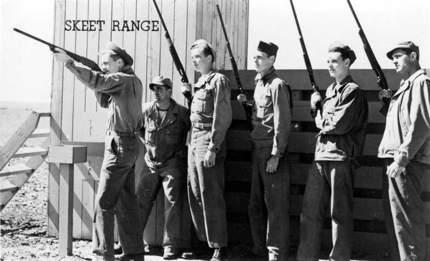 In this undated photo provided by the Mohave Museum of History and Arts, a soldier aims a shotgun at the former skeet range outside of Kingman, Ariz. Soldiers training during World War II practiced at the skeet range with clay pigeons which unknowingly contained hazardous materials.The U.S. Army Corps of Engineers plans to take more steps in cleaning up the site, which tests determined was contaminated by the gun range. Corps officials are set to meet Tuesday, Sept. 9, 2014, at Mohave Community College about a 75-acre area just outside of the city and see if further study and relief are needed. (AP Photo/Courtesy of Mohave Museum of History and Arts)