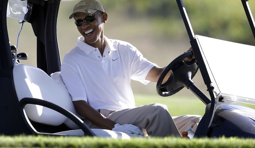 President Barack Obama smiles at the wheel of a golf cart during golfing at Vineyard Golf Club in Edgartown, Mass., on the island of Martha&#x27;s Vineyard, on Aug. 20, 2014. (AP Photo/Steven Senne, File)