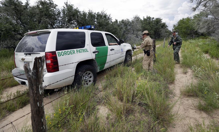 In this Sept. 5, 2014 photo, a U.S. Customs and Border Protection Air and Marine agents and U.S. Customs and Border Protection agents compare notes as they patrol near the Texas-Mexico border, near McAllen, Texas. Since illegal immigration spiked in the Rio Grande Valley this summer, the Border Patrol has dispatched more agents, the Texas Department of Public Safety has sent more troopers and Gov. Rick Perry deployed as many as 1,000 guardsmen to the area. (AP Photo/Eric Gay)