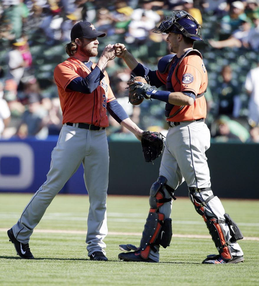 Houston Astros relief pitcher Josh Fields, left, celebrates with catcher Jason Castro after the last out of the game in a 5-3 win over the Oakland Athletics during the ninth inning of a baseball game on Sunday, Sept. 7, 2014, in Oakland, Calif. (AP Photo/Marcio Jose Sanchez)