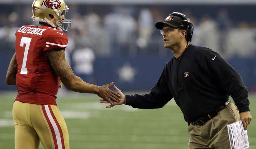 San Francisco 49ers quarterback Colin Kaepernick (7) shakes hands with head coach Jim Harbaugh after a score against the Dallas Cowboys in the first half of an NFL football game, Sunday, Sept. 7, 2014, in Arlington, Texas. (Associated Press) **FILE**