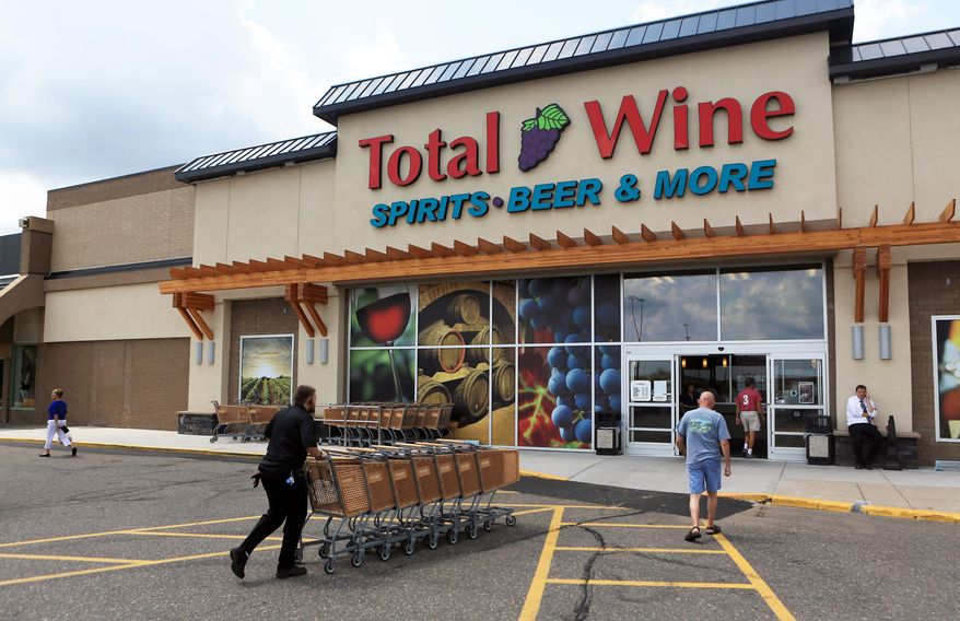 In a July 29, 2014, photo, customers come and go from Total Wine in Roseville, Minn. Small liquor stores in Minnesota are facing increased competition from retail giants that offer greater selections, and often lower prices. Maryland-based Total Wine & More and Target are the newest companies seeking to grab a share of the state's alcohol sales, following the footsteps of many grocery chains and big discount retailers (AP Photo/MPR News, Jeffrey Thompson) **FILE**