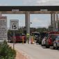 A soldier moves a traffic cone as cars wait to enter Fort Bliss in El Paso, Texas, Tuesday, Sept. 9,  2014. The Army is ramping up security at Fort Bliss, its sprawling West Texas post near the US-Mexico border. The tighter security is to include random vehicle checks and access limited to Defense Department personnel at some of its gates. (AP Photo/Juan Carlos Llorca)
