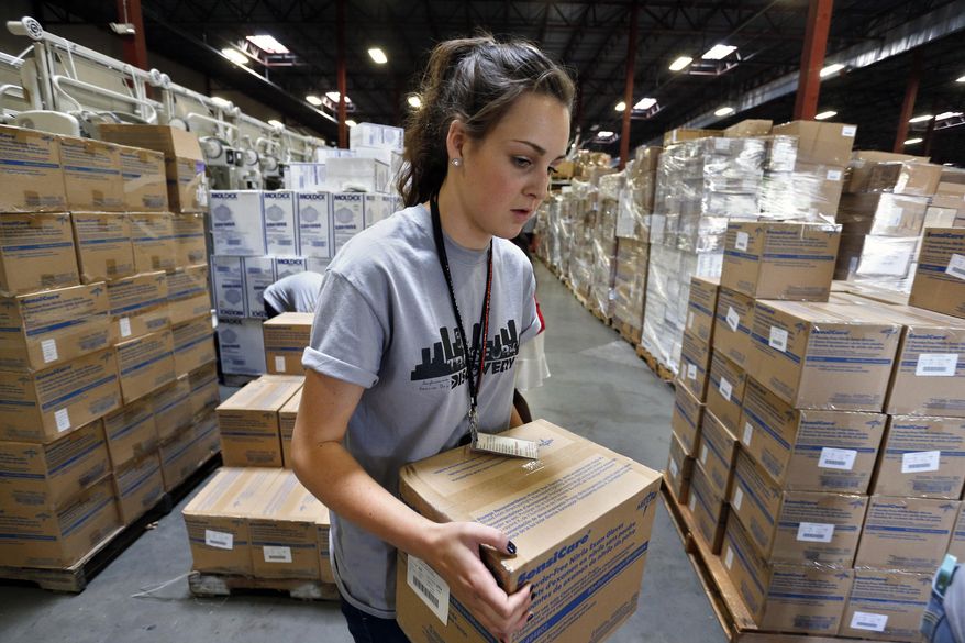 Valor Christian High School sophomore Ashtyn Huppert loads a pallet with medical supplies bound for Sierra Leone to combat Ebola, inside the warehouse of Project C.U.R.E., in Centennial, Colo., Tuesday Sept. 9, 2014. The Colorado-based charity that provides donated medical equipment to developing countries is shipping $400,000 worth of supplies to West Africa to help stop the spread of the Ebola virus. (AP Photo/Brennan Linsley)
