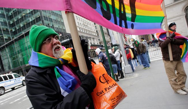 Artist Gilbert Baker, designer of the Rainbow Flag, holds a &quot;Boycott Homophobia&quot; banner before the start of the St. Patrick&#x27;s Day parade in March. Three Irish gay groups are applying to be in the parade after a gay broadcast-employees group was approved. (Associated Press)