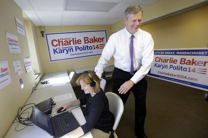 Massachusetts Republican gubernatorial hopeful Charlie Baker, right, smiles while speaking with volunteer Carole Gunst, of Boston, left, at a call center in the Baker campaign headquarters, Monday, Sept. 8, 2014, in Boston. Baker is seeking his party's nomination in the Sept. 9 primary. (AP Photo/Steven Senne)
