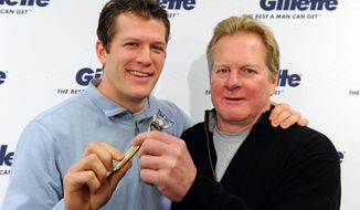 **FILE** Ryan Suter, Minnesota Wild defenseman, and his 1980 Olympic gold medalist father, Bob Suter, before heading to Sochi on Wednesday, Feb. 5, 2014 in St. Paul, Minn. (Photo by Craig Lassig/Invision for Gillette/AP Images)