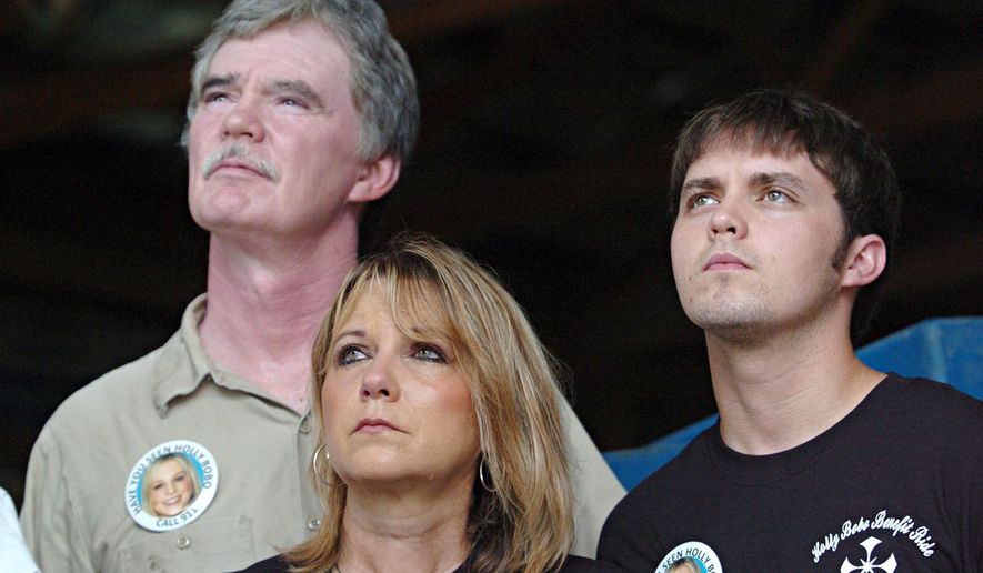 FILE - In this Tuesday, July 12, 2011, file photo, from left, Holly Bobo's father Dana, mother Karen and brother Clint look on during a press conference on Parsons, Tenn. The remains of Holly Bobo were found Sunday, Sept. 7, 2014, in Decatur County, not far from Parsons, about 110 miles east of Memphis. (AP Photo/The Jackson Sun, Aaron Hardin, File) NO SALES