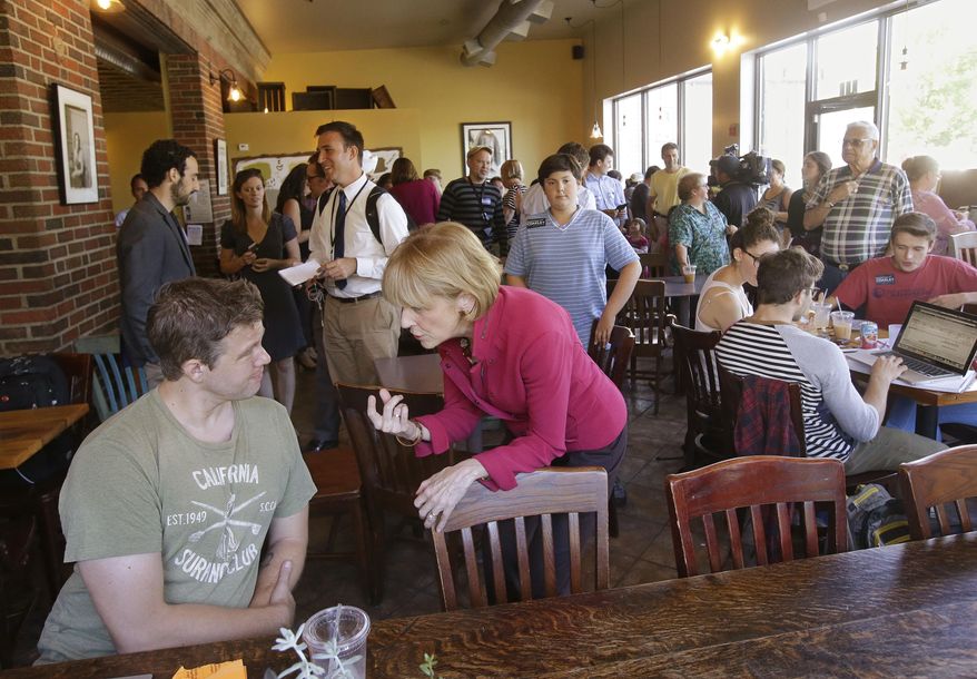 Massachusetts Attorney General and Democratic candidate for governor Martha Coakley engages in a conversation with Jim Cooney about entrepreneur career paths and how they apply to women in particular during a campaign visit at Kickstand Cafe, Monday, Sept. 8, 2014, in Arlington, Mass. (AP Photo/Stephan Savoia)