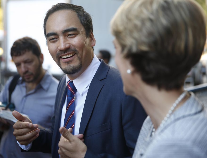 Zephyr Teachout, a Democratic gubernatorial candidate, right, listens while Tim Wu, a Democratic lieutenant gubernatorial candidate, speaks to the media before voting in New York, Tuesday, Sept. 9, 2014. New York Gov. Andrew Cuomo faces a challenge in his bid for a second term in the Democratic primary as he seeks to dispatch liberal activist Teachout. Also on the ballot is Columbia University law professor Tim Wu, Teachout's choice for lieutenant governor. (AP Photo/Seth Wenig)